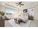 Spacious main bedroom featuring a tray ceiling, ceiling fan, and a large window for tons of natural light at 6370 Twilight Ave, Firestone, CO 80504