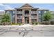 Inviting three-story condo with balconies, brick accents, and verdant landscaping provides an appealing exterior view at 804 Summer Hawk Dr # 6105, Longmont, CO 80504