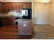 Modern kitchen with granite countertops, wooden cabinets and an adjacent carpeted dining area at 804 Summer Hawk Dr # 6105, Longmont, CO 80504