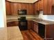 Efficient kitchen featuring granite counters, wooden cabinets, and black appliances at 804 Summer Hawk Dr # 6105, Longmont, CO 80504