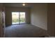 Neutral living room with natural light from sliding glass door, offering outdoor views at 804 Summer Hawk Dr # 6105, Longmont, CO 80504