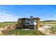 Beautiful modern home with large windows, a balcony and concrete patio in a large yard at 11115 Evening Hunt Rd, Franktown, CO 80116