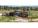 Expansive home with a modern design, outdoor patios, lush greenery, and mountain views at 11115 Evening Hunt Rd, Franktown, CO 80116