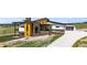Modern home with stone and wood facade and large driveway on a sunny day at 11115 Evening Hunt Rd, Franktown, CO 80116