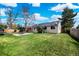 Expansive backyard featuring a lush lawn and patio area, perfect for outdoor entertaining at 1765 S Endicott St, Lakewood, CO 80232