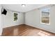 Bedroom with hardwood floors and two windows offering natural light at 1765 S Endicott St, Lakewood, CO 80232