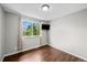 Bedroom with hardwood floors and large window at 1765 S Endicott St, Lakewood, CO 80232