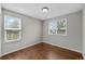 Bedroom with hardwood floors and two windows at 1765 S Endicott St, Lakewood, CO 80232
