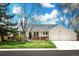 Charming ranch-style home with a two-car garage, manicured lawn, and welcoming front porch at 1765 S Endicott St, Lakewood, CO 80232