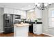 Bright kitchen with stainless steel appliances, an island, and ample storage space at 1765 S Endicott St, Lakewood, CO 80232