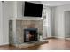 Attractive fireplace with slate tile and a mounted television is the focal point of this living area at 1765 S Endicott St, Lakewood, CO 80232