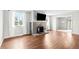 Inviting living room featuring hardwood floors and a cozy stone fireplace with mounted television at 1765 S Endicott St, Lakewood, CO 80232