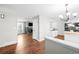 Open-concept living area with hardwood floors seamlessly connecting the living room and kitchen spaces at 1765 S Endicott St, Lakewood, CO 80232