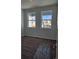 Bright bedroom with carpet flooring and two large windows at 498 Grey Rock St, Brighton, CO 80601