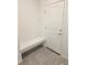 Bright entryway with built-in bench and neutral tile flooring at 498 Grey Rock St, Brighton, CO 80601