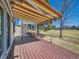 Inviting back deck with a striped awning, offering outdoor living space and views of the green area at 2446 S Vaughn Way # A, Aurora, CO 80014