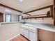 Finished basement wet bar with white cabinets, light countertop, and wood detailing at 2446 S Vaughn Way # A, Aurora, CO 80014