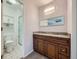 Bathroom featuring a double sink vanity with granite countertop and a walk-in shower at 2446 S Vaughn Way # A, Aurora, CO 80014