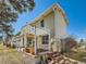 The back of this townhome features a back deck with an awning, a garden and a green backyard at 2446 S Vaughn Way # A, Aurora, CO 80014