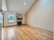 Open living room with vaulted ceiling, fireplace with stone surround, and natural light at 2446 S Vaughn Way # A, Aurora, CO 80014