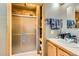 Bathroom showcasing a shower with sliding doors and a sink with towels, providing a functional and tidy space at 4 Virginia St, Idaho Springs, CO 80452