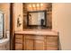 Bathroom vanity with light-wood cabinets, wood accent wall, framed mirror and three-bulb vanity light at 4 Virginia St, Idaho Springs, CO 80452