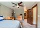 Bedroom with a ceiling fan, dresser, and a door to the Primary bath at 4 Virginia St, Idaho Springs, CO 80452