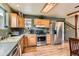 Full kitchen with a stainless steel refrigerator, range and wood cabinets at 4 Virginia St, Idaho Springs, CO 80452