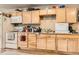 Traditional kitchen boasts light wood cabinets, essential appliances, and a practical layout for cooking and meal preparation at 4 Virginia St, Idaho Springs, CO 80452