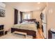 Comfortable main bedroom features a large bed, natural light, and an adjacent laundry area for added convenience at 4 Virginia St, Idaho Springs, CO 80452