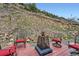 Outdoor patio with chairs, a fire pit, and hillside views at 4 Virginia St, Idaho Springs, CO 80452
