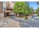 Property entrance featuring natural stone and landscaping with mature trees at 7000 E Quincy Ave # 317, Denver, CO 80237