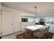 Open dining room featuring contemporary lighting, seating for six, and seamless flow to the living area at 7000 E Quincy Ave # 317, Denver, CO 80237