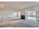 Large living area with fireplace and adjoining sunroom providing ample natural light and space at 7000 E Quincy Ave # 317, Denver, CO 80237