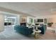 Bright living room with plush carpet, modern decor, fireplace, and adjacent dining area with scenic view at 7000 E Quincy Ave # 317, Denver, CO 80237