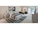 Serene main bedroom showcasing neutral tones, stylish decor, and access to a private balcony at 7000 E Quincy Ave # 317, Denver, CO 80237