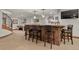 Basement bar area with ample seating, decorative lighting, and entertainment space at 4839 Bandera Pl, Parker, CO 80134