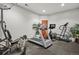 Spacious workout area with sleek black flooring and a variety of exercise equipment at 4839 Bandera Pl, Parker, CO 80134