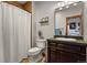 Cozy bathroom featuring a shower with curtain, modern vanity, and neutral tones at 4839 Bandera Pl, Parker, CO 80134