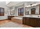 Luxurious bathroom with a soaking tub, double vanity sinks, and ample natural light at 4839 Bandera Pl, Parker, CO 80134