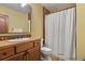 Charming bathroom with warm wood cabinets, stylish tile accents, and a shower-tub combo at 4839 Bandera Pl, Parker, CO 80134