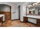 Elegant bathroom featuring double vanity sinks, a large mirror, and a glass enclosed shower at 4839 Bandera Pl, Parker, CO 80134