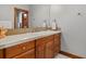 Bathroom featuring wood cabinets, a white sink, and decorative wall tiles at 4839 Bandera Pl, Parker, CO 80134