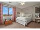Bright bedroom with a large window, white furniture, and soft, neutral tones at 4839 Bandera Pl, Parker, CO 80134