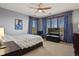Bedroom with large windows, wood trim, a ceiling fan, and cozy decor at 4839 Bandera Pl, Parker, CO 80134