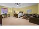 Cozy bedroom with a plush sofa, soft carpet, and a charming ceiling fan at 4839 Bandera Pl, Parker, CO 80134