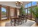 Elegant dining room with a chandelier, hardwood floors, large windows, and access to an outdoor patio at 4839 Bandera Pl, Parker, CO 80134