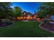 Beautiful home with manicured lawn, stone accents, large windows, and professional landscaping with mature trees at 4839 Bandera Pl, Parker, CO 80134