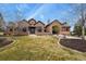 Lovely home featuring a stone facade, porte-cochère, and a beautifully landscaped front yard at 4839 Bandera Pl, Parker, CO 80134