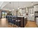 Bright kitchen with a large island, breakfast bar, and views of the outdoor area at 4839 Bandera Pl, Parker, CO 80134